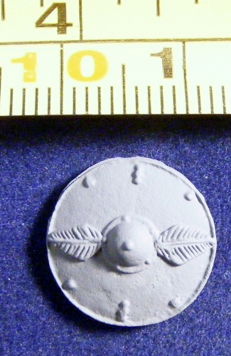 ACR49 round shield with leaf motif